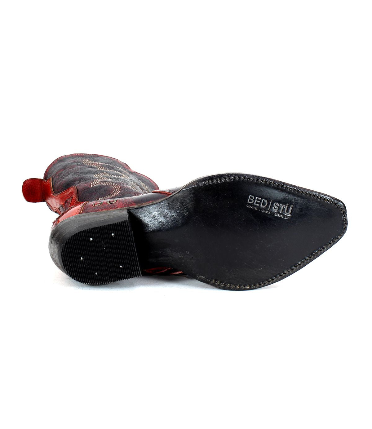 The Deuce by Bed|Stü is a black and red Western boot shown sole-up, revealing the Bed|Stü brand name embossed on the black, pointed sole. Crafted from premium vegetable-tanned leather, this boot also features detailed stitching that highlights its quality craftsmanship.