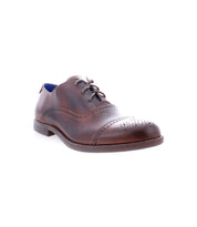 The Donatello II by Bed|Stü is a single brown leather oxford shoe, crafted from vegetable-tanned leather with laces, decorative perforations, and an elegant cap-toe design, shown against a white background.