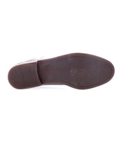 The image shows the bottom view of the Donatello II by Bed|Stü, a brown leather oxford shoe featuring a smooth sole with minimal tread near the heel and toe, expertly crafted from premium vegetable-tanned leather.