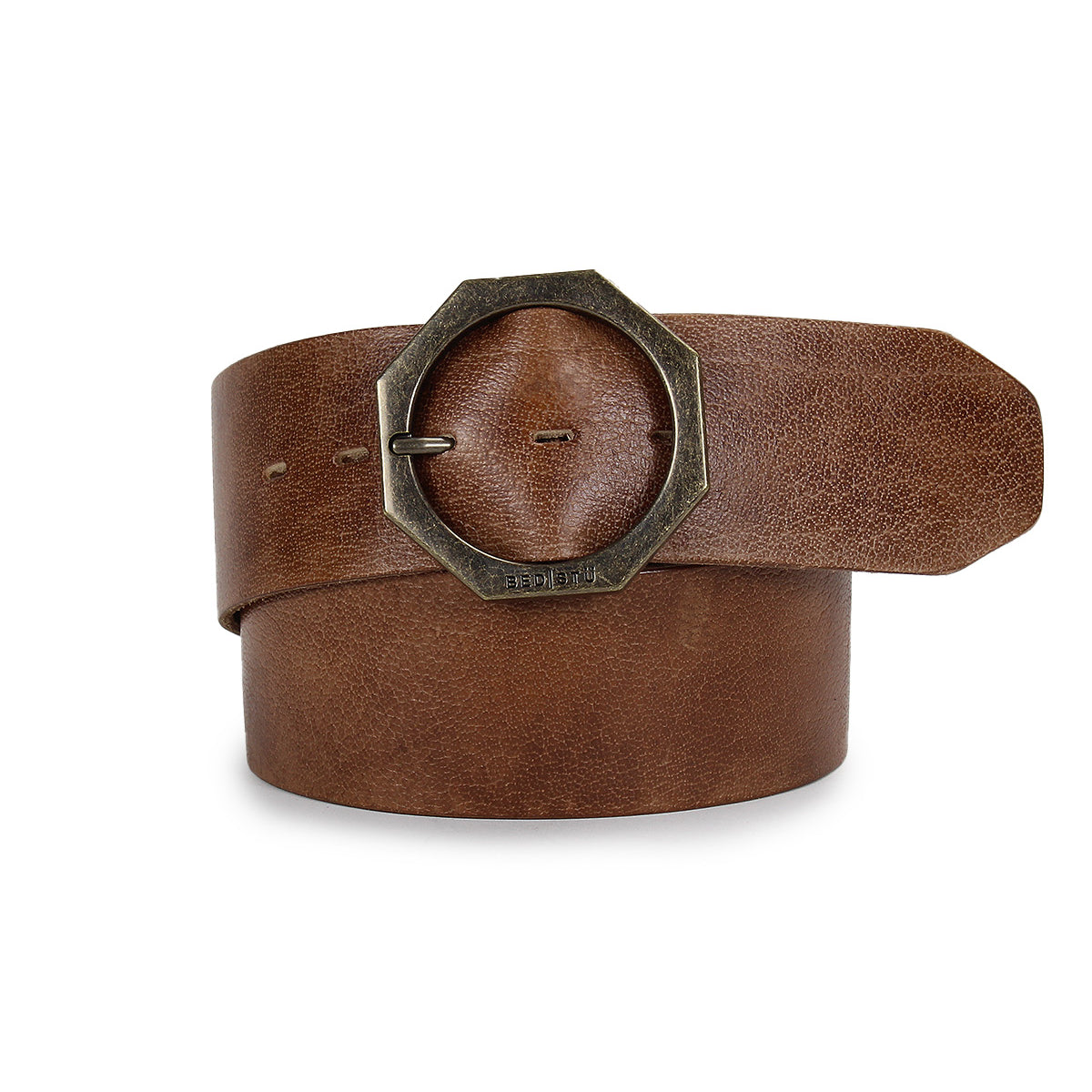 Bed|Stü’s Dreampath genuine leather belt, showcased rolled up with its tip tucked under the octagon metal buckle.