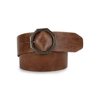 Bed|Stü’s Dreampath genuine leather belt, showcased rolled up with its tip tucked under the octagon metal buckle.