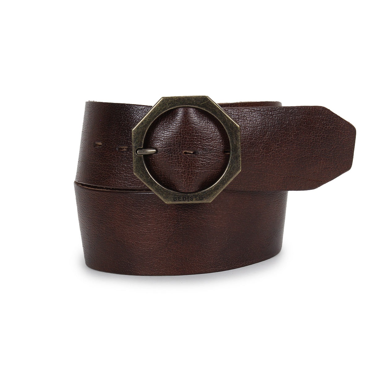A rolled Bed|Stü Dreampath genuine leather belt with a large, octagon brass-colored metal buckle is displayed against a white background.