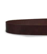 A close-up of a dark brown Bed|Stü Dreampath genuine leather belt laid flat on a white surface, showing only the middle portion without the octagon metal buckle or holes visible.