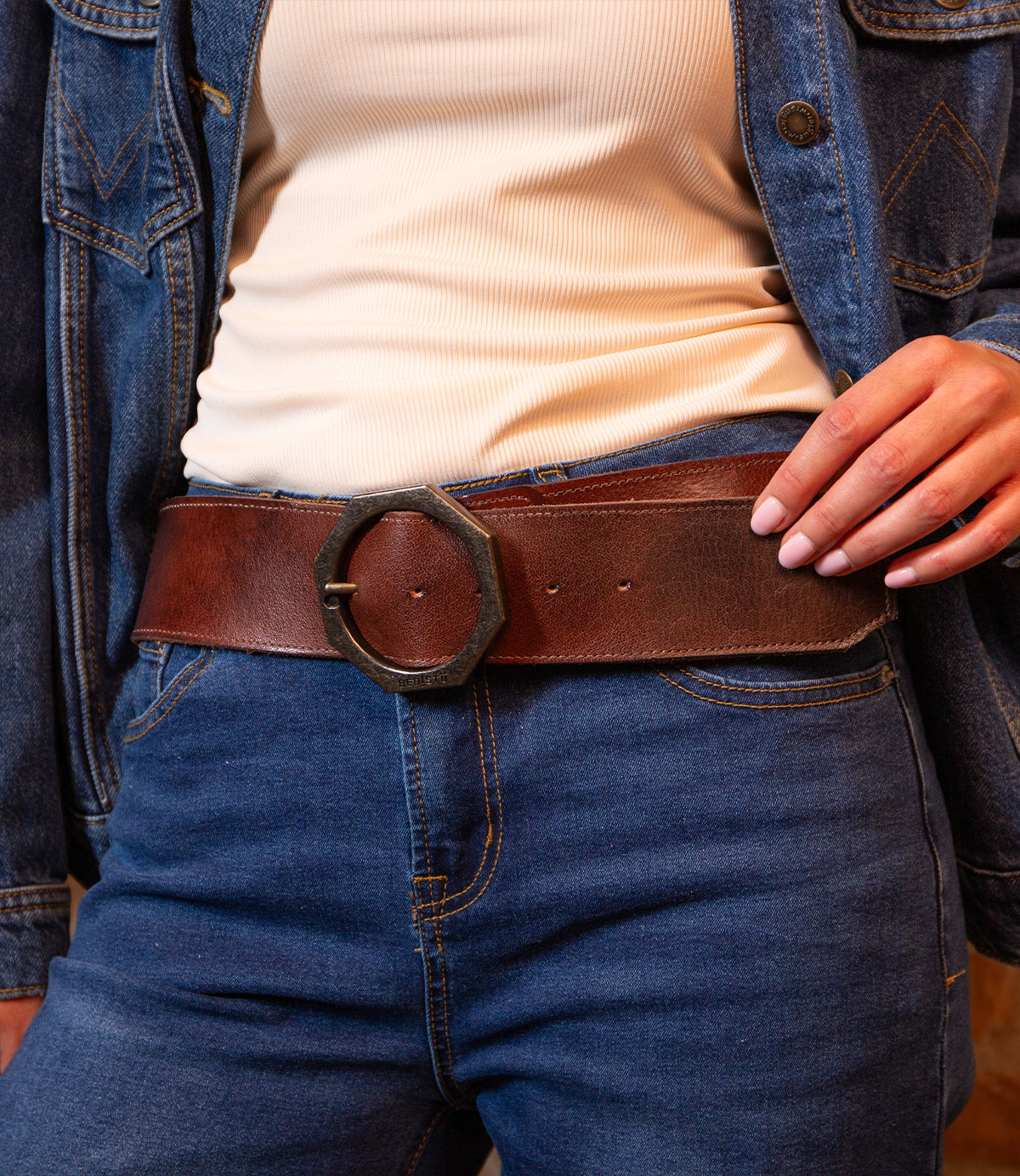 Person wearing a cream ribbed shirt, blue denim jacket, and jeans accessorized with the BED|STÜ Dreampath genuine leather belt featuring a large octagon metal buckle.