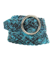 The Bed|Stü Dreamweaver belt, a turquoise and black woven leather accessory featuring artisan craftsmanship and a round silver buckle, is coiled on a white background.