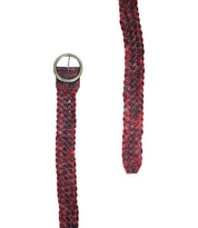 Introducing Dreamweaver by Bed|Stü: a bohemian-inspired woven leather belt, artfully braided in striking red and black hues. This accessory features a round metal buckle and highlights exquisite artisan craftsmanship, beautifully displayed laid flat with one end apart from the other.