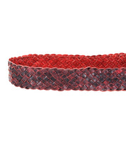 The Bed|Stü Dreamweaver belt, crafted from woven leather in striking red and black hues, is displayed up close to highlight its artisan craftsmanship against a clean white background.