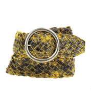 The Bed|Stü Dreamweaver belt, crafted from woven black and yellow leather with artisan detailing, features a large round silver buckle and is displayed neatly coiled on a white background.