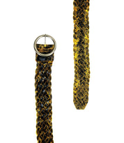 Close-up of the Dreamweaver braided belt by Bed|Stü, featuring artisan craftsmanship in its black and yellow woven pattern and round metal buckle, displayed against a white background.
