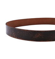 A close-up of the Bed|Stü Drifter, featuring a brown textured leather strap with a weathered, minimal design, displayed in a circular shape against a white background.