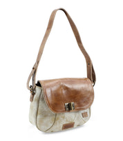 The Bed|Stü Elect small shoulder bag, featuring a light beige body, brown leather flap, adjustable strap, and metal clasp closure, is displayed against a white background—exuding vintage charm that's perfect for everyday use.