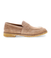 The Bed|Stü Envoy is a tan suede handcrafted loafer featuring a low heel, visible stitching, and a textured rubber sole, displayed in a left side profile view against a white background.