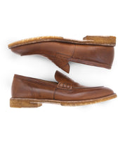 Two Bed|Stü Envoy brown Italian leather loafers are placed side by side, one facing right and the other facing left, against a white background—showcasing the elegance of premium men's footwear.