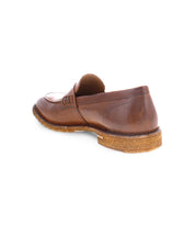 Introducing Envoy by Bed|Stü—a premium men’s footwear option. This handcrafted brown leather loafer features a durable rubber sole and is presented from the rear side angle against a white background.