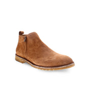 The Evade by Bed|Stü is a brown suede ankle boot featuring a side zipper, rounded toe, and light tan crepe sole, handcrafted in Italy and shown against a plain white background.