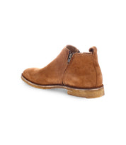 The Evade by Bed|Stü is a men's brown suede ankle boot featuring dual side zippers and a durable rubber sole, expertly handcrafted in Italy. Shown angled to highlight the outer side and back against a white background.