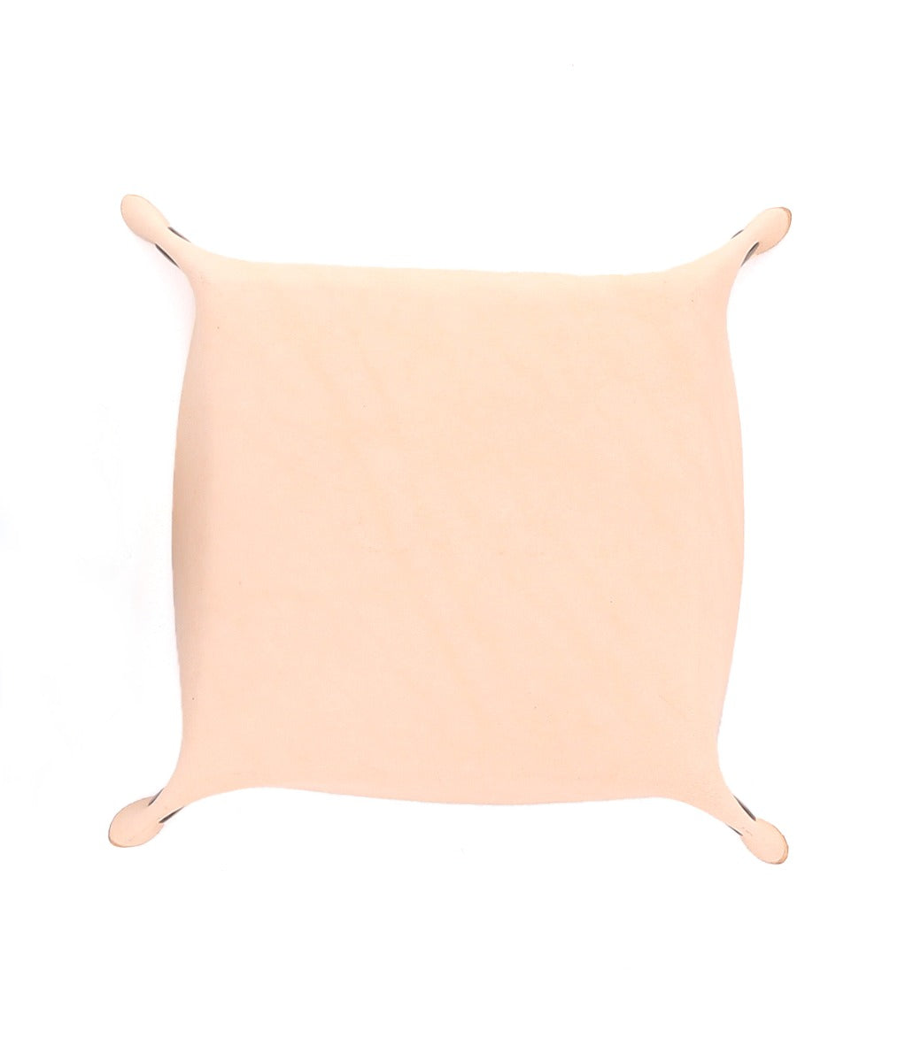 A rectangular Expanse Catchall Tray by Bed|Stü, crafted from beige synthetic skin and echoing minimalist valet tray design, is stretched and pinned at the corners against a white background.