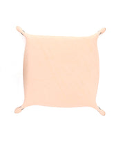 A rectangular Expanse Catchall Tray by Bed|Stü, crafted from beige synthetic skin and echoing minimalist valet tray design, is stretched and pinned at the corners against a white background.