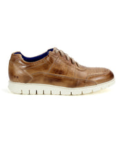 The Bed|Stü Fairman is a men's brown leather sneaker featuring three-tone leather accents, perforated detailing, laces, and a lightweight white sole, displayed from the side on a white background.