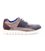 The Fairman men's sneaker by Bed|Stü showcases three-tone leather panels in brown, grey, and black, accented with grey laces, blue lining, and a lightweight white rubber sole. Shown in a side profile on a white background.