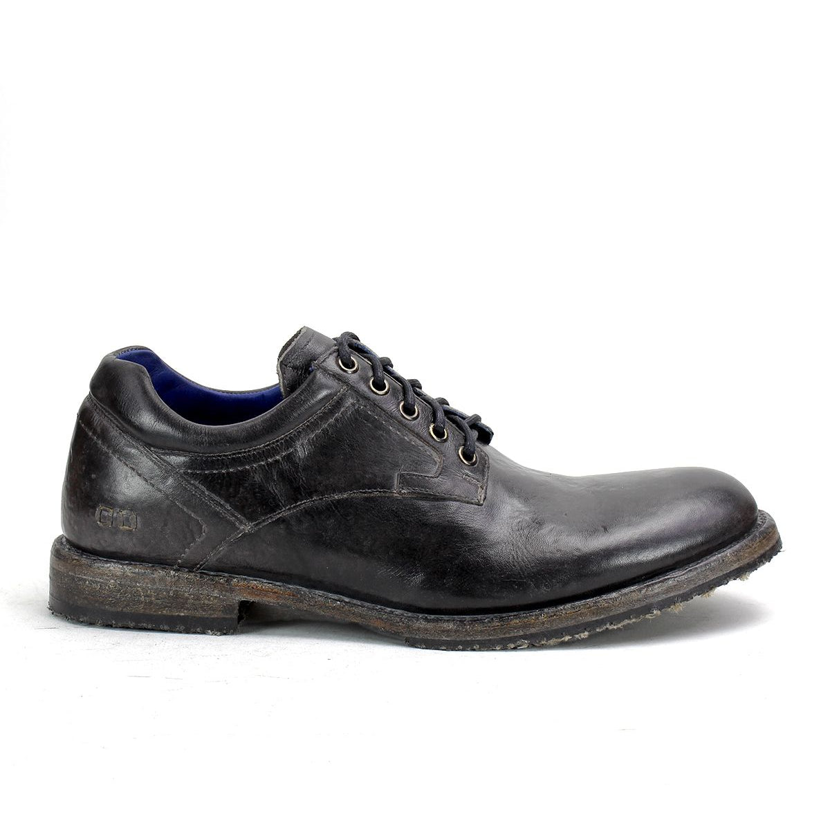 A single Bed|Stü Fierce black washed leather derby lace-up dress shoe with a worn sole, shown in profile on a white background.