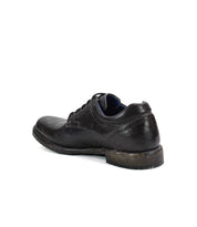 A single Fierce black washed leather derby dress shoe by Bed|Stü is shown from the back on a white background, highlighting its slightly worn sole and laces. The timeless look is complemented by durable Goodyear welt construction.