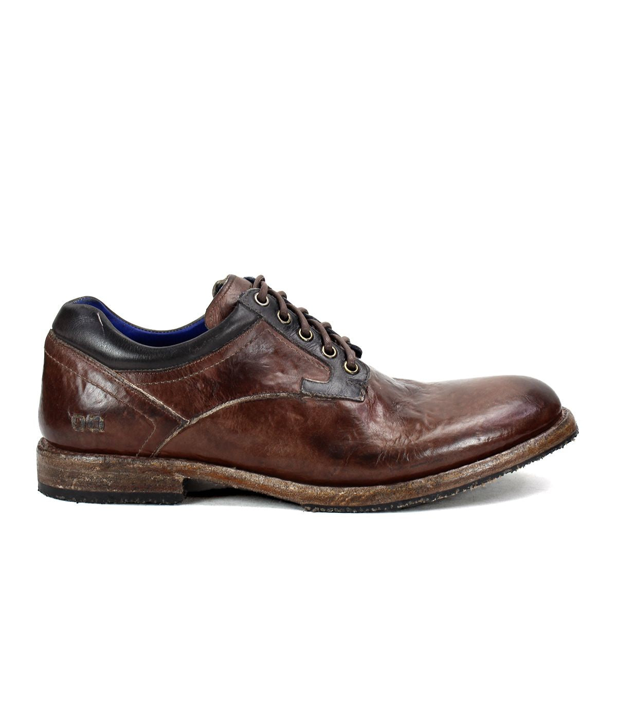 The Bed|Stü Fierce shoe is a brown washed leather derby lace-up dress shoe featuring a worn finish, low wooden sole, and black collar detail, displayed in side profile against a white background.