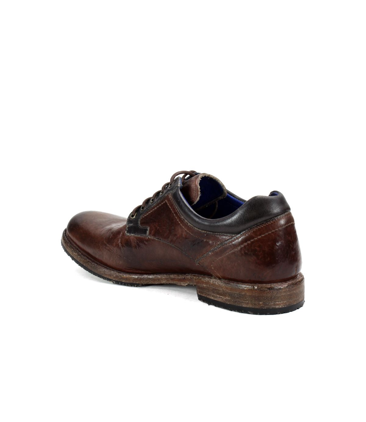 Here’s a rewritten sentence using the provided product data: The Bed|Stü Fierce is a brown washed leather derby dress shoe with laces, shown from the back left side, featuring creased leather, a worn sole, and classic Goodyear welt construction.