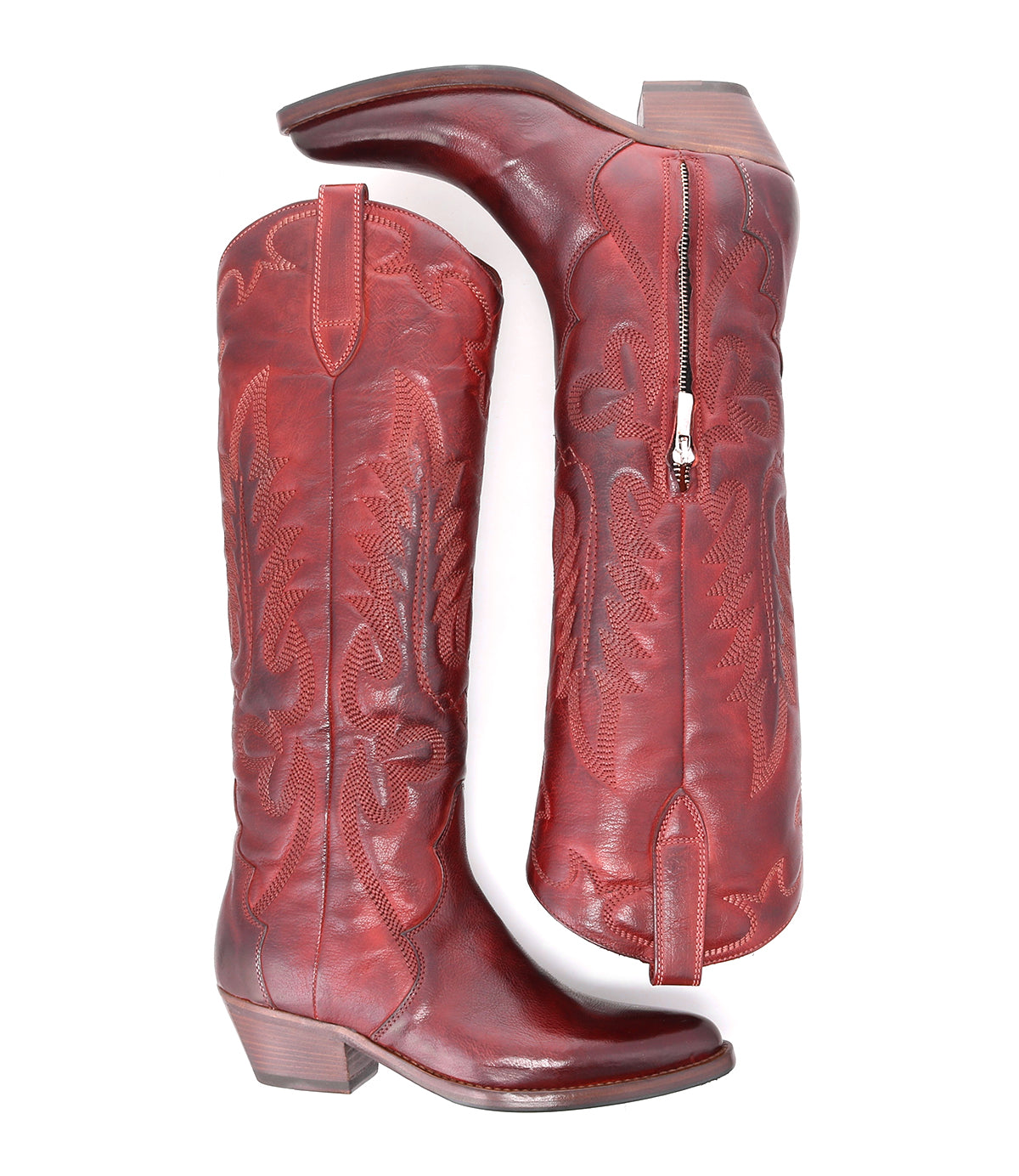 Step out in style with the Finito boots from Bed|Stü—a tall, red leather cowboy design featuring decorative stitching, a classic western silhouette, side zipper, and medium heel. Displayed in both side and bottom views against a white background.
