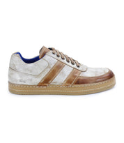 The Firepower sneaker by Bed|Stü is shown in a left side profile view, featuring beige and brown shades with two brown leather stripes on the sides, a tan textured sole, and brown laces.