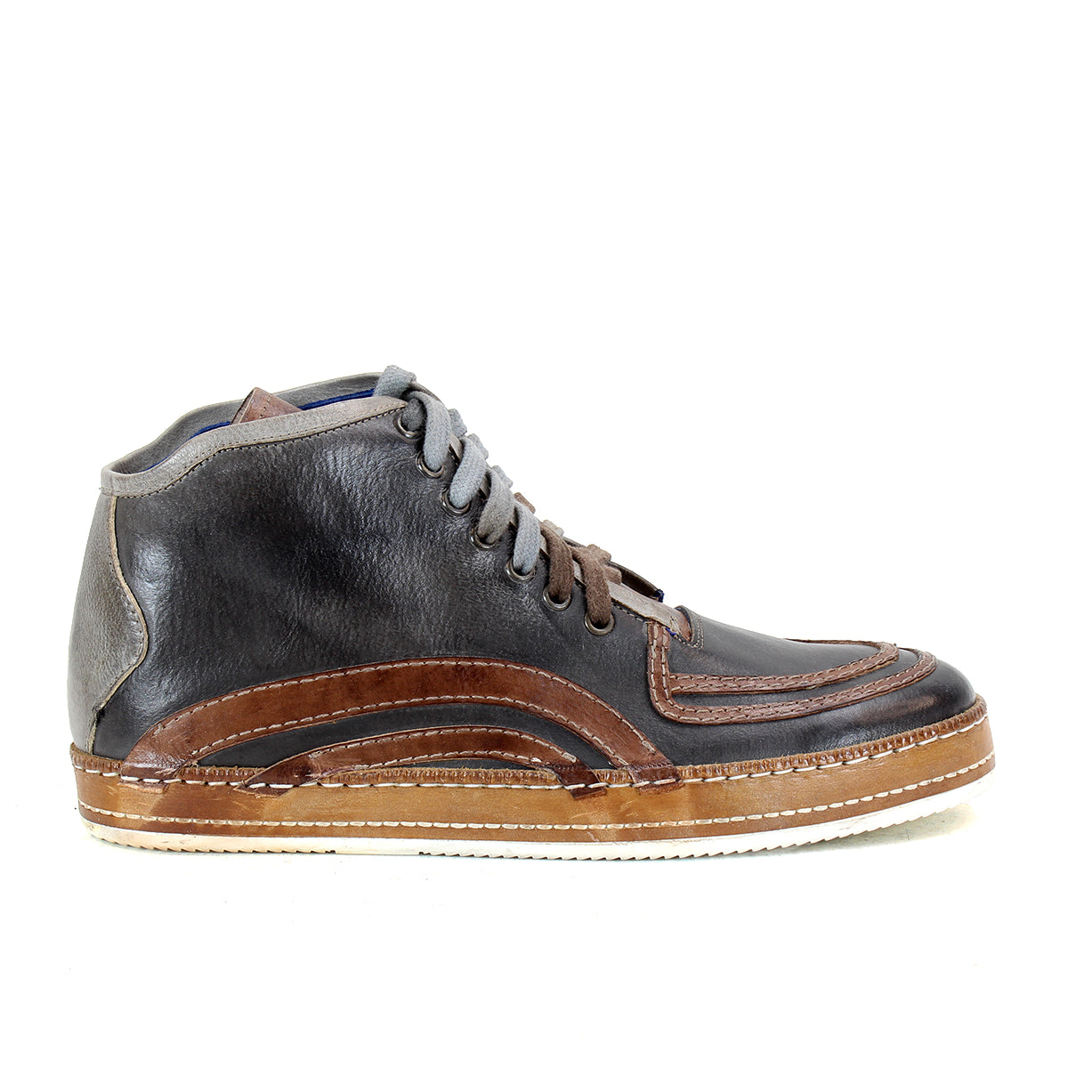 Introducing the Formation sneaker by Bed|Stü, featuring brown and gray leather with classic paneling, laces, a low ankle profile, and a flat light brown sole. Seen from the side against a white background, this design draws inspiration from vintage court sneakers for a blend of timeless style and modern craftsmanship.
