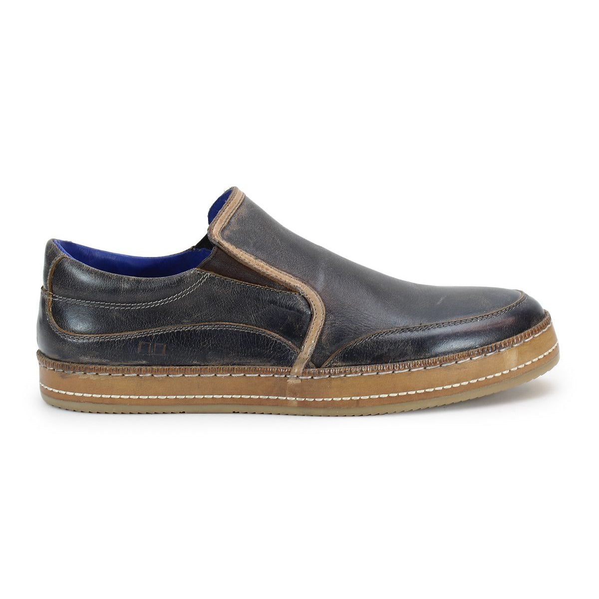 Bed|Stü Freestyle slip-on sneaker in brown leather with visible stitching, tan rubber sole, and a low-profile design featuring leather trim, shown from the left side against a white background.