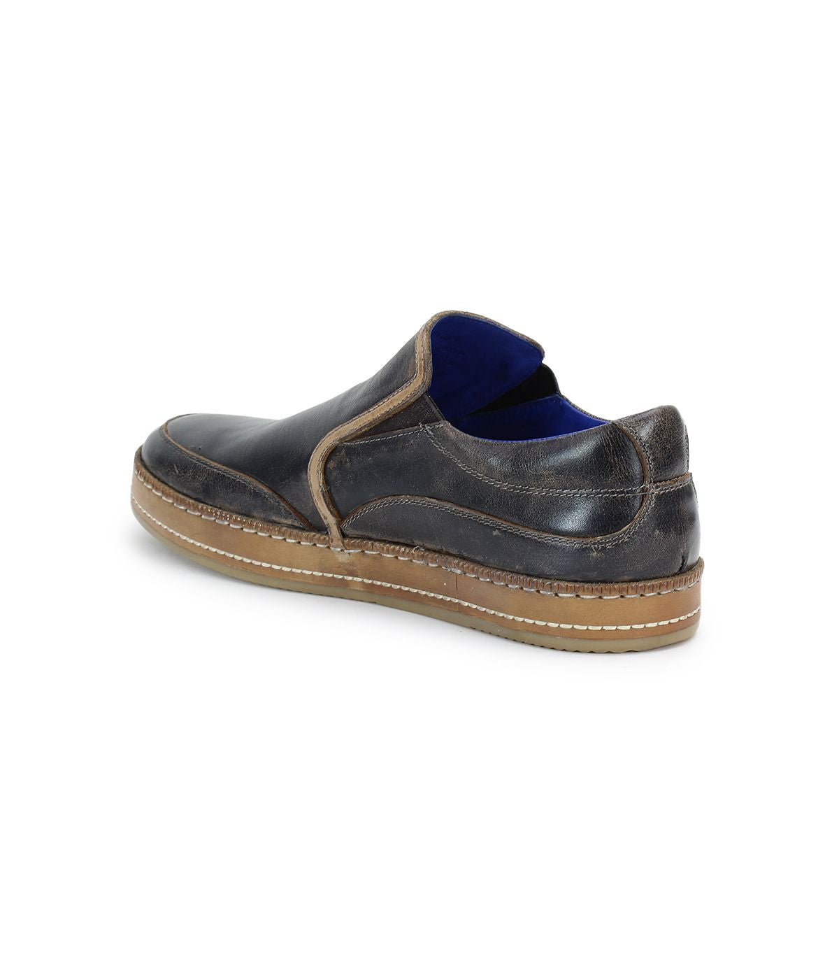 A single Bed|Stü Freestyle dark brown leather slip-on sneaker with visible stitching, leather trim, a tan rubber sole, and blue lining is photographed at an angle against a white background.