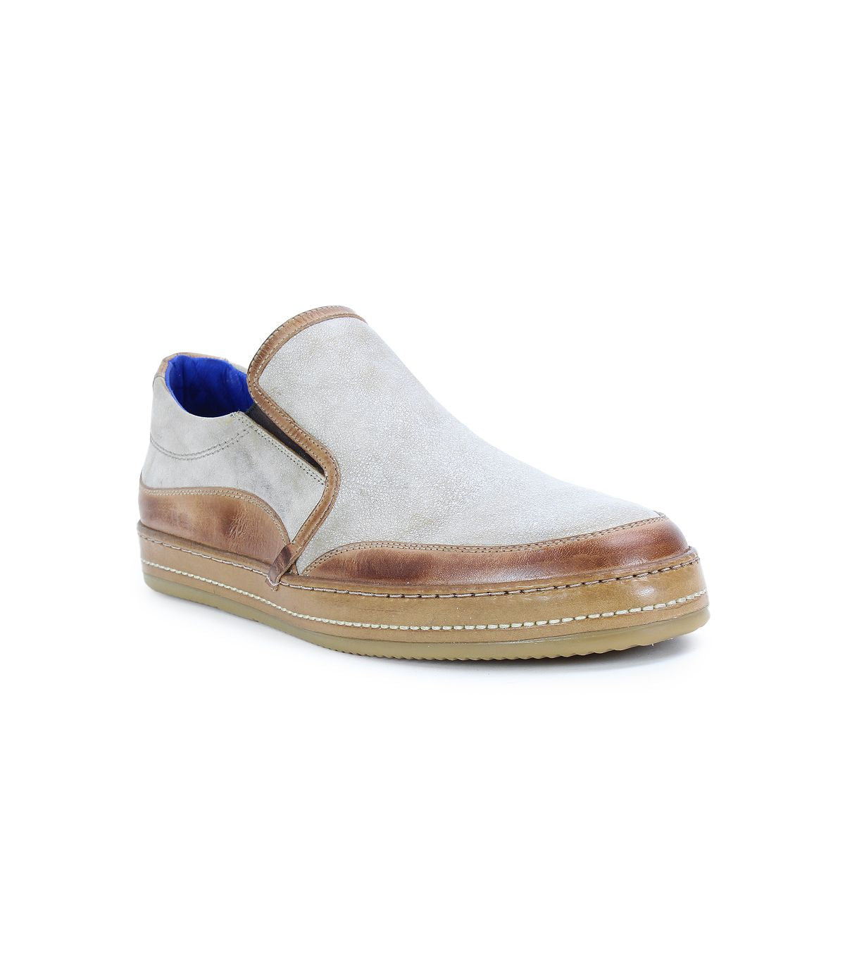 The Bed|Stü Freestyle slip-on sneaker features a light gray upper, brown leather trim, a tan rubber sole, and a blue inner lining, displayed at a slight angle against a white background.