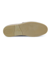 The image shows the bottom view of the Bed|Stü Freestyle sneaker, featuring a beige, comfortable sole with horizontal ridges and a smooth oval-shaped section near the middle.
