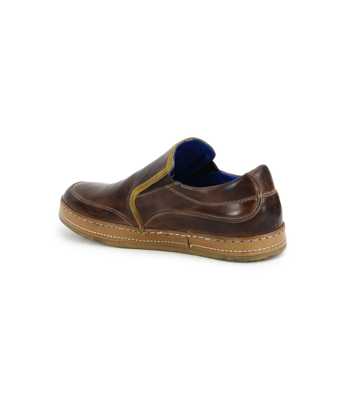 The Bed|Stü Freestyle slip-on sneaker is crafted in brown leather with tan stitching, a yellow accent trim, and a blue inner lining. This comfortable sneaker features a subtle leather trim and is shown from the back side angle against a white background.