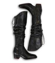 The Leilani boots by Bed|Stü feature black leather, side zippers, slouchy knee-high shafts with elegant ruching, decorative stitching, and low block heels—making them a true stand-out style.