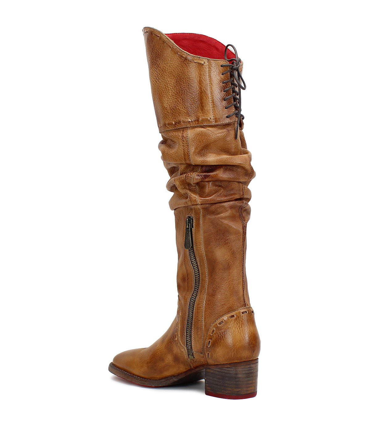 Side view of the Leilani by Bed|Stü—a tall, standout brown leather boot featuring a stacked heel, side zipper, slouchy shaft with elegant ruching, red lining, and back laces detailing the rear.