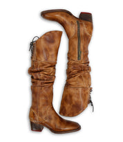 The Leilani boots by Bed|Stü feature tall, brown leather shafts with elegant ruching, side zippers, back laces at the top, slouchy silhouettes, and low heels—stand-out details showcased against a white background.