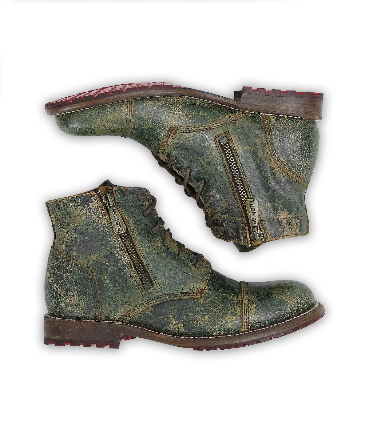 A pair of Bed|Stü Bonnie II distressed green leather combat ankle boots with cap toes and side zippers, featuring a Goodyear-welted outsole, are stacked one on top of the other and displayed on a white background.