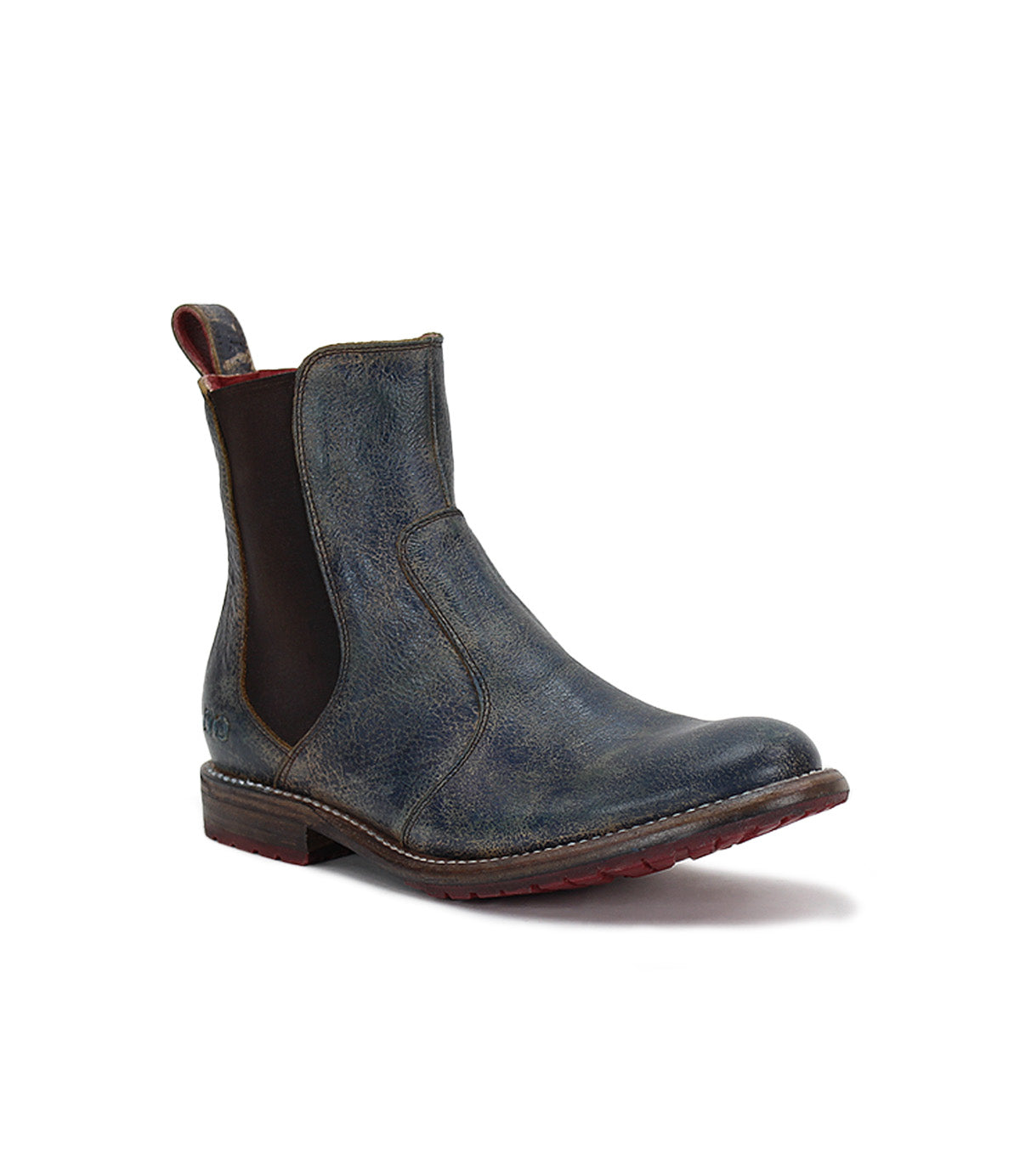 Introducing the Nandi Chelsea boot by Bed|Stü—a distressed blue leather design featuring brown elastic side panels, a back pull tab, and a low stacked heel. This versatile shoe offers a convenient slip-on style for effortless comfort and timeless appeal.
