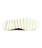 The image displays the white rubber sole of the Bed|Stü Galahad shoe, viewed from underneath, showcasing wide horizontal grooves for traction—a lightweight and supportive foundation ideal for these high-top sneakers.