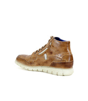 The Bed|Stü Galahad sneakers in brown leather feature a cream-colored lightweight sole, shown from a rear side angle against a white background.