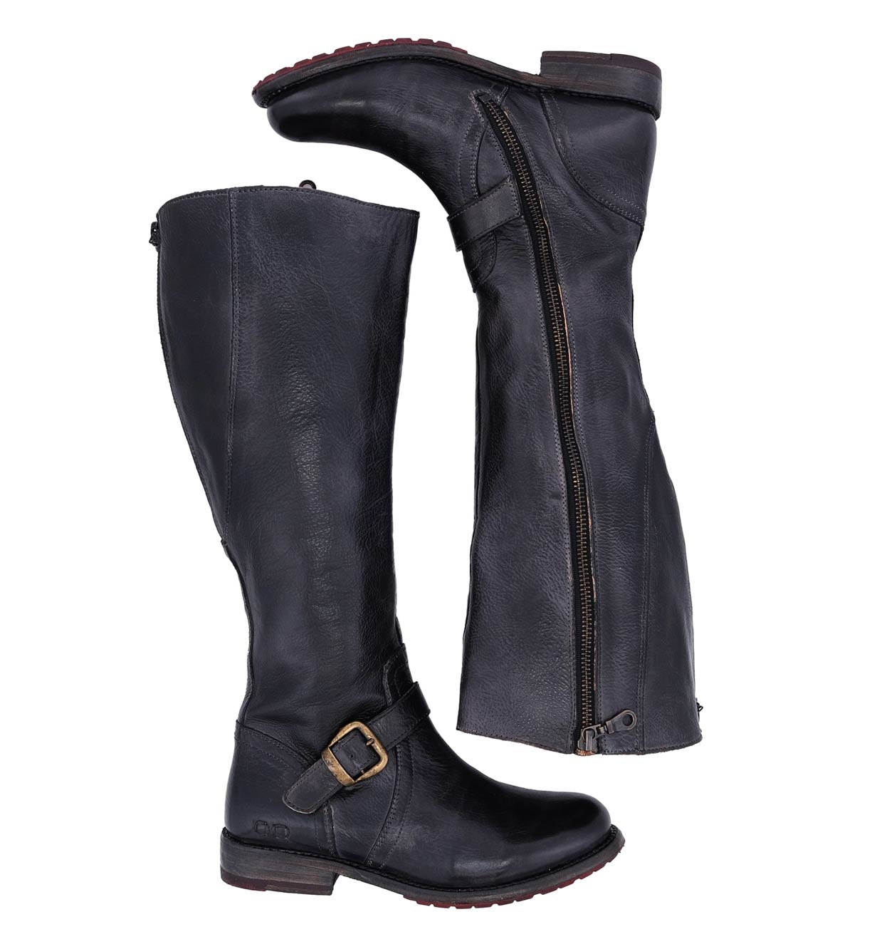 A pair of Glaye Wide Calf boots by Bed|Stü in tall black leather, featuring side zippers and decorative buckles, shown from the side with one boot lying flat to display the zipper.