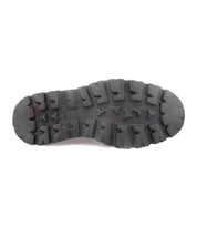 A black rubber sole with deep, rugged treads and triangular patterns, photographed from the bottom against a white background—showcasing the sturdy foundation of the Goer Italian work-style boot by Bed|Stü, expertly crafted for durability and style.