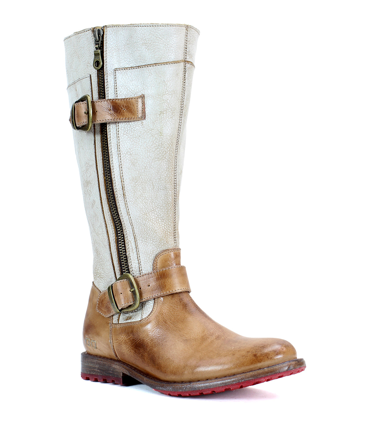 The Bed|Stü Gogo Lug is a tall, tan mid-calf leather boot featuring a side zipper, two decorative buckles, a low heel, and a striking red sole with a sturdy lug outsole—pictured against a white background.
