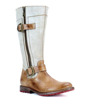The Bed|Stü Gogo Lug Wide Calf is a tall, brown and beige leather mid-calf boot featuring a side zipper, two buckles, and a low red-tread sole, displayed on a white background.