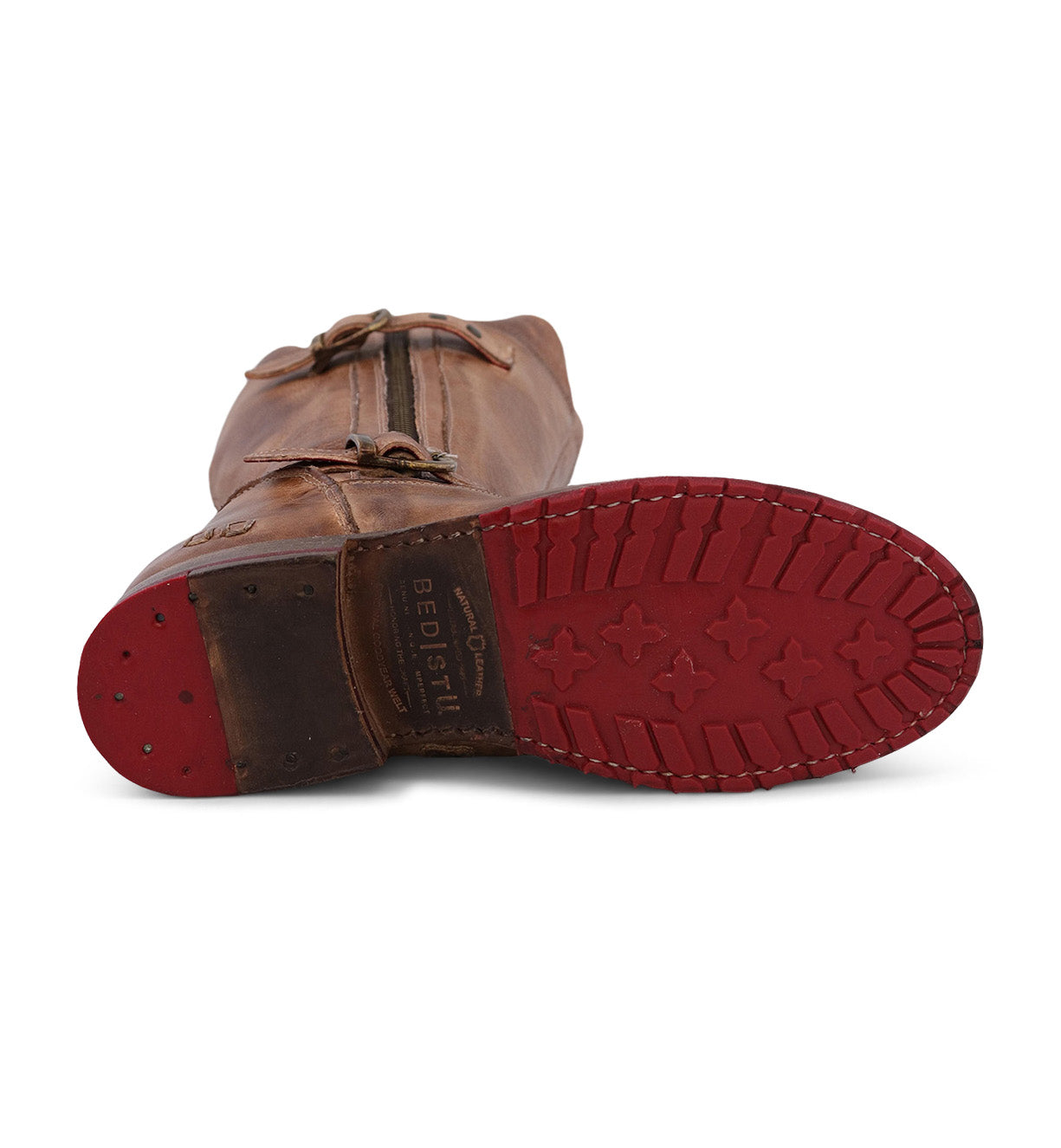A brown leather Gogo Lug Wide Calf boot from Bed|Stü lies on its side, displaying a red rubber sole with star-shaped treads and the brand's "BED|STÜ" stamp near the heel.