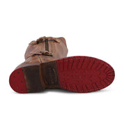 A brown leather Gogo Lug Wide Calf boot from Bed|Stü lies on its side, displaying a red rubber sole with star-shaped treads and the brand's "BED|STÜ" stamp near the heel.