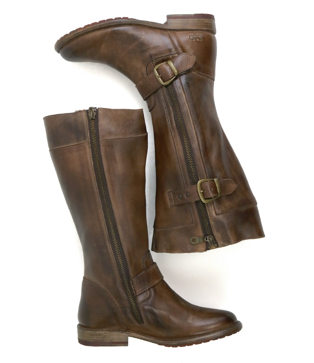 Step out in style with the Bed|Stü Gogo Lug Wide Calf boots—tall brown leather mid-calf boots featuring side zippers, buckles, and low stacked heels, displayed on a white background.